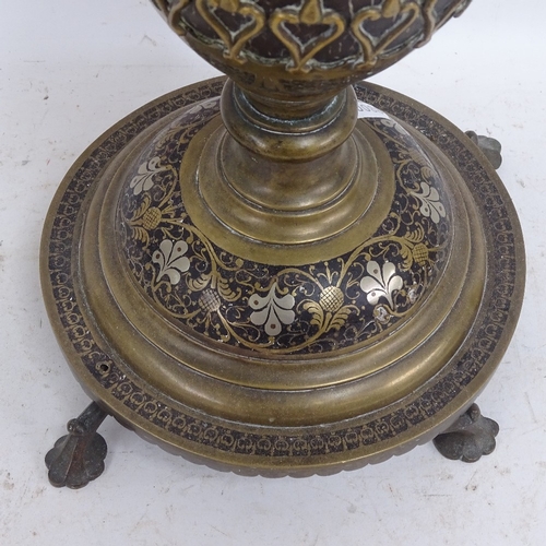 584 - A Middle Eastern brass and black enamel table lamp, and a pair of cream painted wood table lamps, br... 