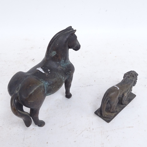 585 - A heavy cast-brass horse and lion, horse length 17cm (2)