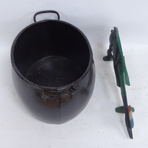 594 - A cast-iron 4 gallon caldron, and a painted cast-iron biplane ornament, length 50cm (2)