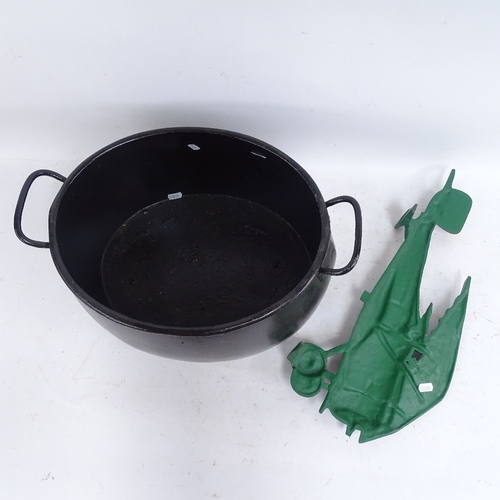 594 - A cast-iron 4 gallon caldron, and a painted cast-iron biplane ornament, length 50cm (2)