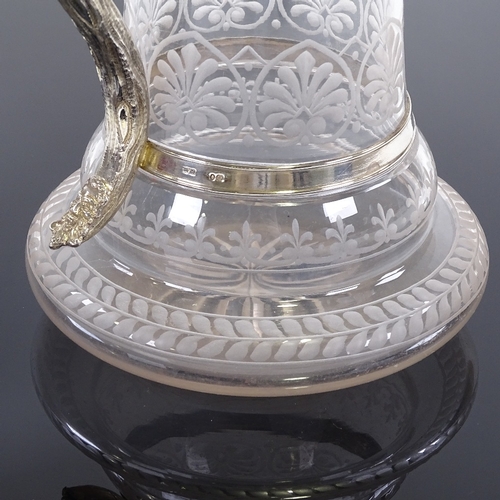 12 - A Victorian silver mounted etched glass claret jug, with Bacchanalian detail and lion thumb plate, h... 