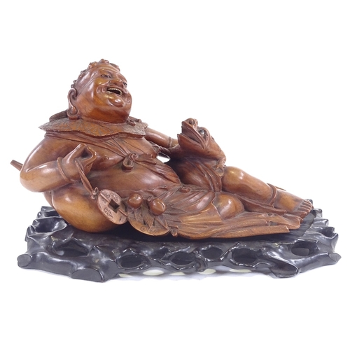 24 - A 19th century carved wood Chinese deity with toad, probably God of wealth and good fortune, on hard... 