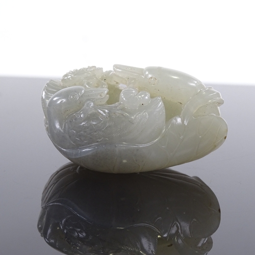 27 - A Chinese celadon jade carving, probably 18th or 19th century, in the form of a Swan and Cygnet on a... 
