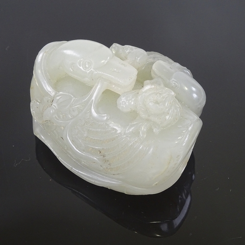 27 - A Chinese celadon jade carving, probably 18th or 19th century, in the form of a Swan and Cygnet on a... 