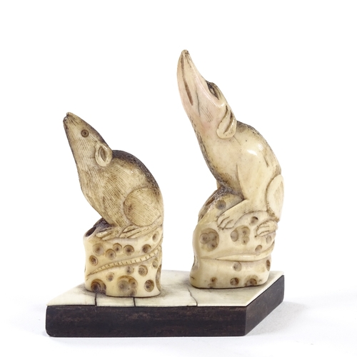 29 - A pair of carved stag horn netsuke rats, on common 
hardwood and ivory base, height 7cm.