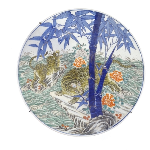 30 - A large Japanese Meiji period porcelain charger, with enamel decoration of tigers' in flood, blue un... 
