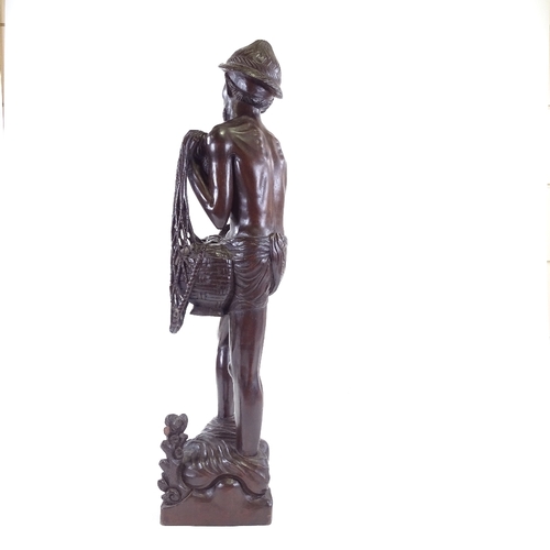 100 - A Chinese hardwood carving of a fisherman, early 20th century, height 65cm.