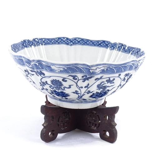 103 - A Chinese blue and white porcelain bowl, hand painted decoration, diameter 25cm, on hardwood stand