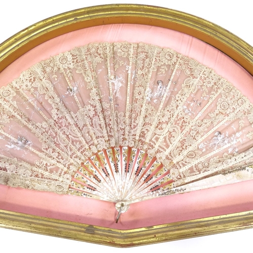 109 - A hand painted lace fan, with carved mother of pearl and ivory sticks, in frame, frame width 76cm.