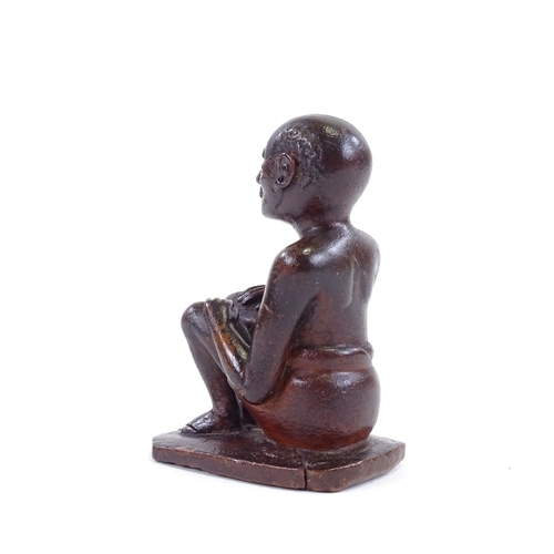 120 - An Indian 19th century wood carving of a seated man, height 9.5cm