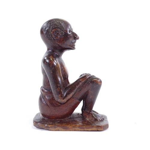 120 - An Indian 19th century wood carving of a seated man, height 9.5cm