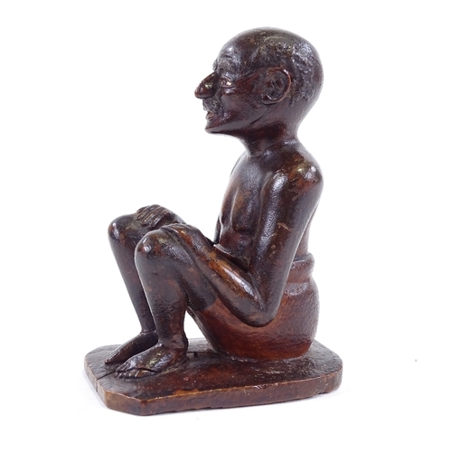 120 - An Indian 19th century wood carving of a seated man, height 9.5cm