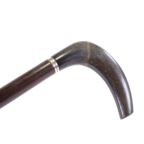 121 - A horn walking cane with silver collar and hardwood shaft