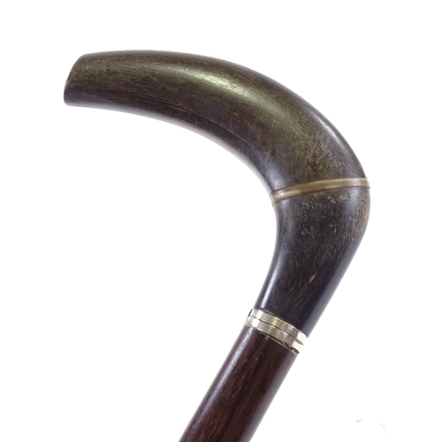 121 - A horn walking cane with silver collar and hardwood shaft