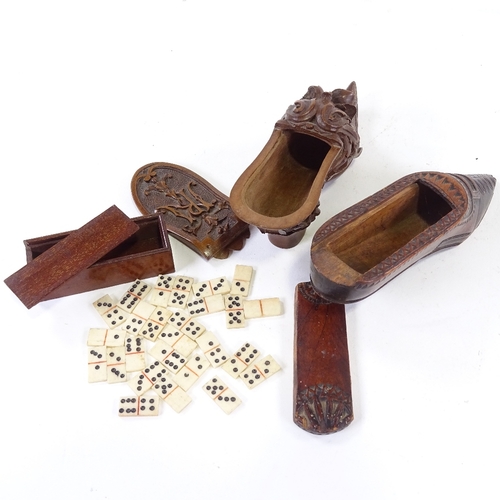 123 - 2 carved wood snuff shoe boxes, and a box of minature bone dominoes. (3)