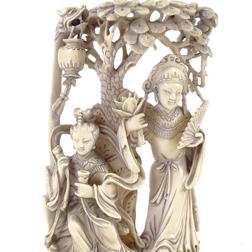 131 - A late 19th/early 20th century Chinese ivory carving, two women with lotus flower, height 20cm.