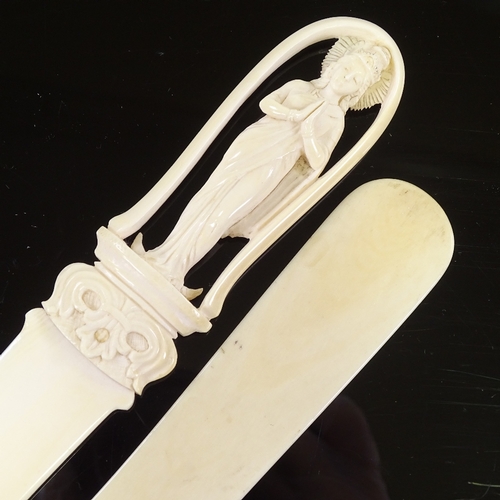 135 - A Chinese ivory paper knife with relief carved handle in the form of a deity, length 30cm, and a pla... 