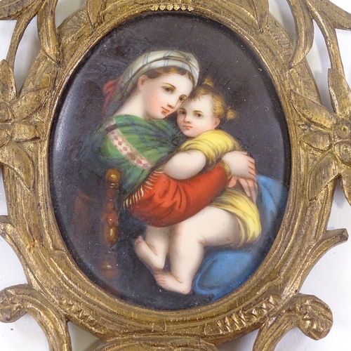 57 - A 19th century painted porcelain plaque, depicting a woman and child in carved giltwood frame, heigh... 