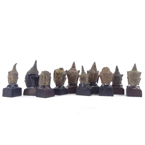 59 - 10 miniature cast bronze Thai Buddha heads, with later made hardwood stands, tallest 6cm with stand.