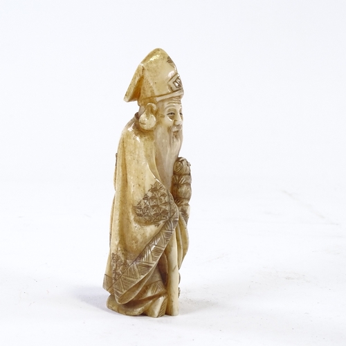 61 - A carved ivory okimono, Sage figure with hare, height 11cm.