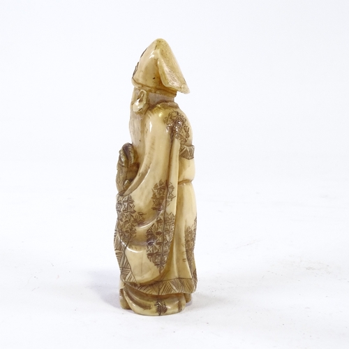 61 - A carved ivory okimono, Sage figure with hare, height 11cm.