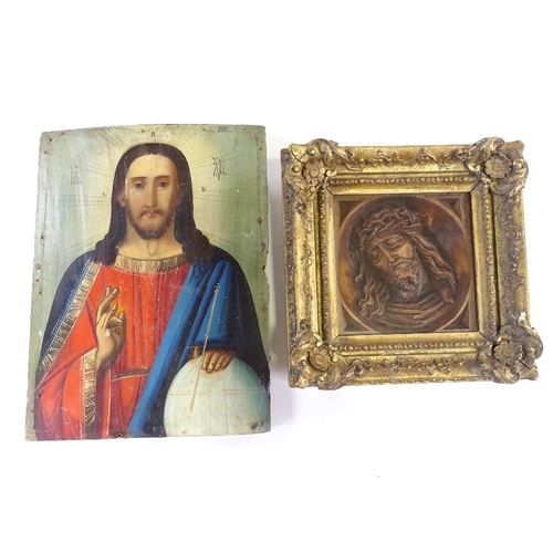 64 - A 19th/20th century painted Russian icon on wood panel, together with a wood carved Christ in gilt f... 