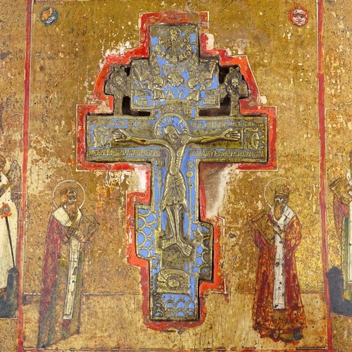 65 - A 19th century Russian relief cast brass and enamel icon crucifix, set in painted and gilded icon wo... 