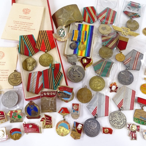 66 - A collection of Russian medals and badges, including military and public service awards.