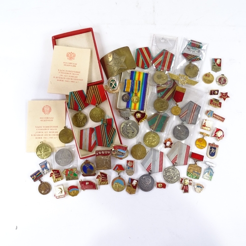 66 - A collection of Russian medals and badges, including military and public service awards.