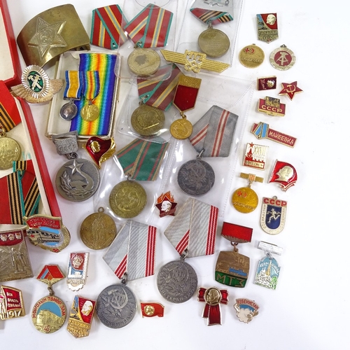 66 - A collection of Russian medals and badges, including military and public service awards.