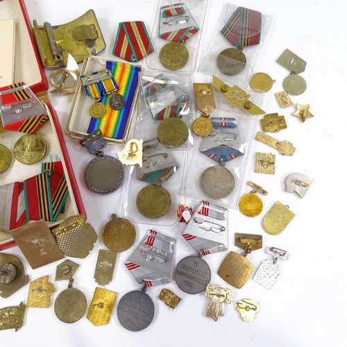 66 - A collection of Russian medals and badges, including military and public service awards.