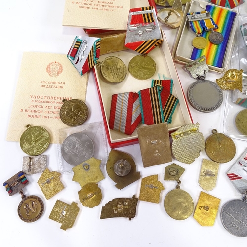 66 - A collection of Russian medals and badges, including military and public service awards.