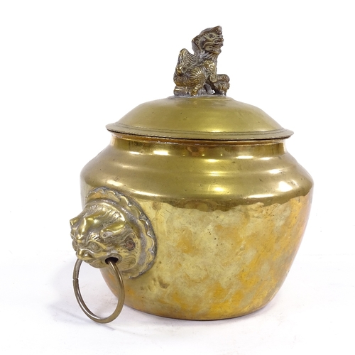 68 - A Chinese polished bronze bowl and cover with lion ring handles, surmounted by a Dog of Fo, height 2... 