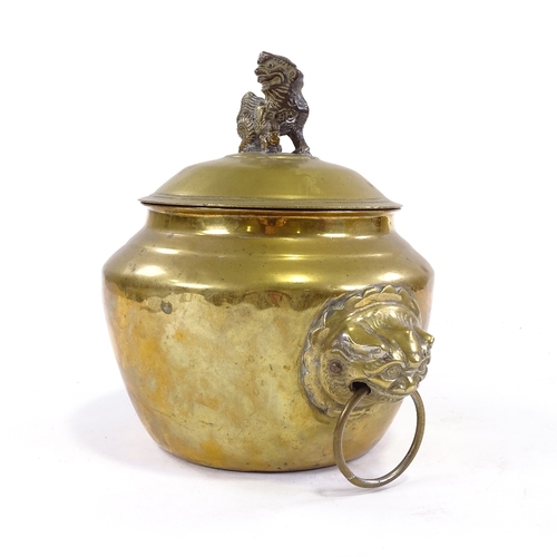 68 - A Chinese polished bronze bowl and cover with lion ring handles, surmounted by a Dog of Fo, height 2... 