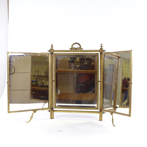 78 - 3 fold dressing table mirror, with ornate brass frame, bakelite panel have moulded and painted decor... 