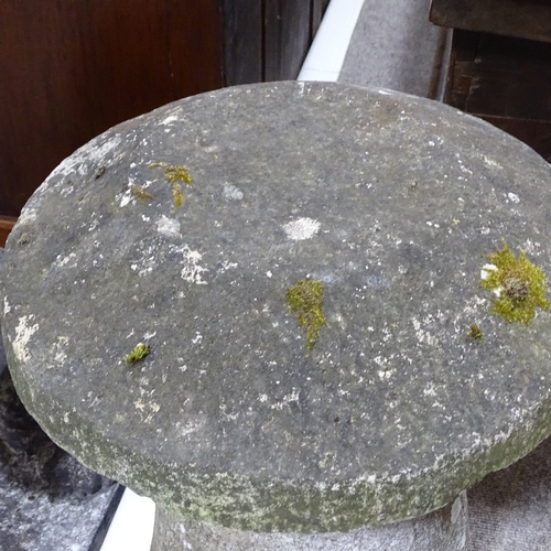 117 - A weathered stone saddle stone, height 74cm, diameter 41cm