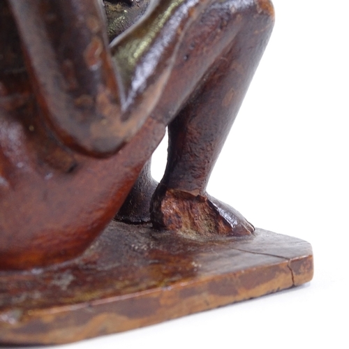 120 - An Indian 19th century wood carving of a seated man, height 9.5cm