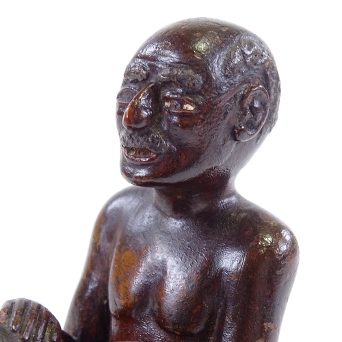 120 - An Indian 19th century wood carving of a seated man, height 9.5cm