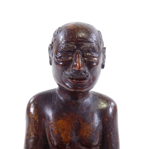 120 - An Indian 19th century wood carving of a seated man, height 9.5cm