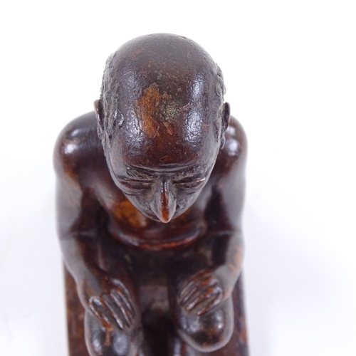 120 - An Indian 19th century wood carving of a seated man, height 9.5cm