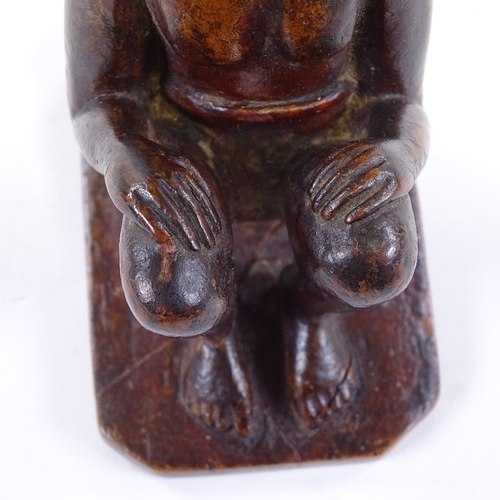 120 - An Indian 19th century wood carving of a seated man, height 9.5cm