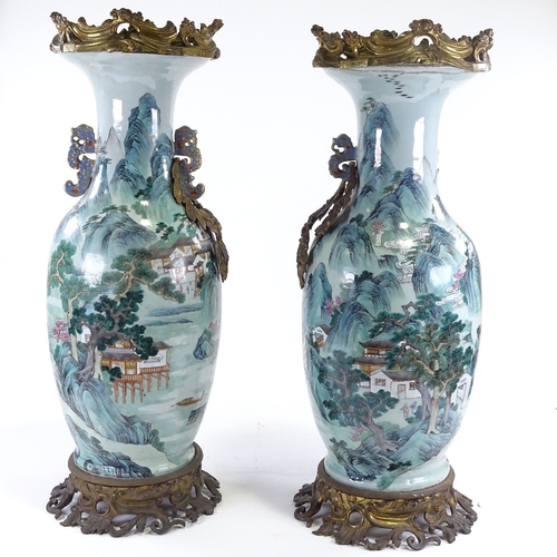 31 - A pair of large 18th century Chinese enamelled porcelain vases, hand painted with extensive mountain... 