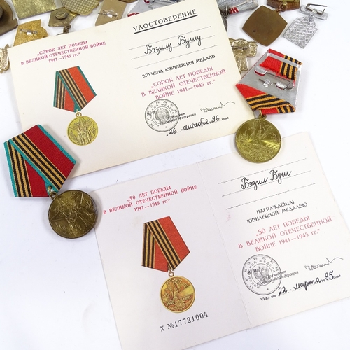 66 - A collection of Russian medals and badges, including military and public service awards.