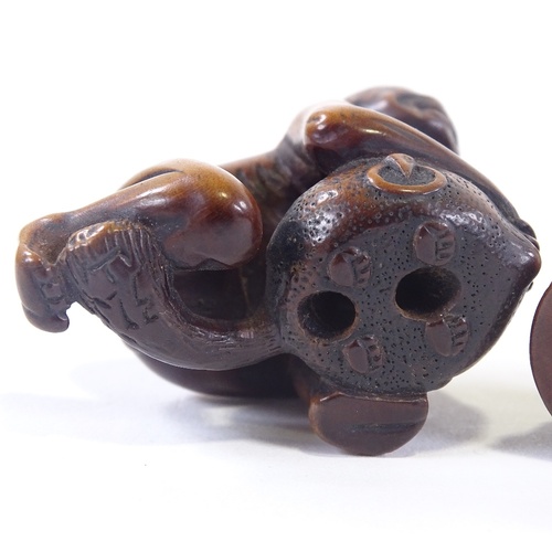 17 - 2 hardwood netsuke of a dog and a man with beaver, tallest 4cm