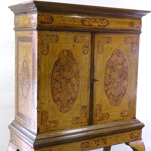 33 - A William and Mary style walnut and marquetry inlaid cabinet on stand, enclosing drawers and central... 