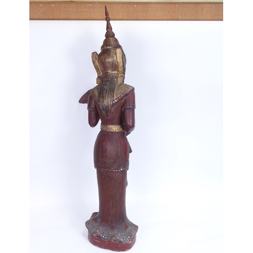 16 - A large Burmese carved lacquered and gilded wood Nat figure on plinth, overall height 93cm