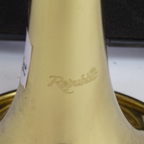 34 - A Republic gold lacquered 3-valve trumpet, length 54cm, in original fitted carrying case