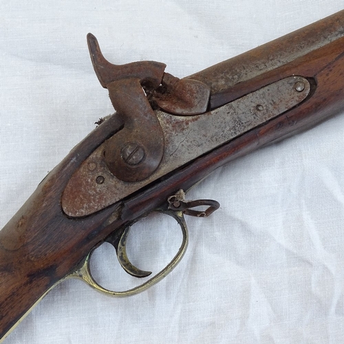 7 - A 19th century percussion musket rifle, brass strapwork and ram rod, with indistinct engraved inscri... 