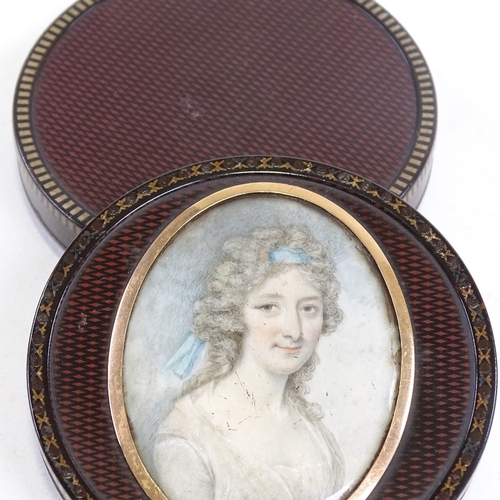 180 - A fine early 19th century circular lacquer box with painted crosshatch design, the lid having an ins... 