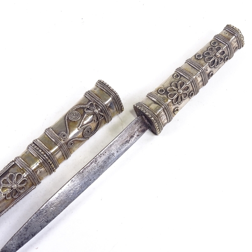 198 - A Middle Eastern white metal cased dagger, with filigree decoration, length 28cm.